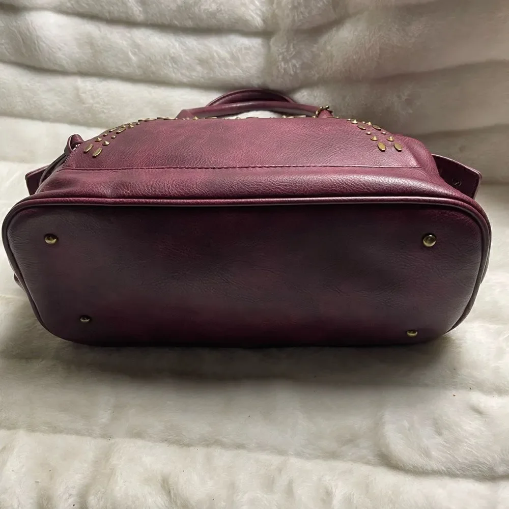 Steve Madden burgundy faux leather satchel with rustic studs accent.
